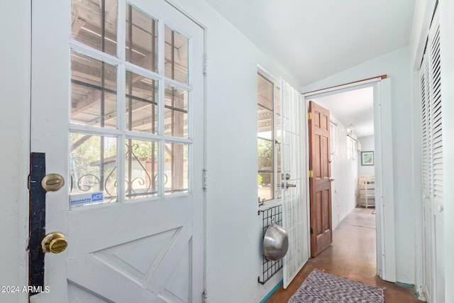 entryway with vaulted ceiling and hardwood / wood-style flooring