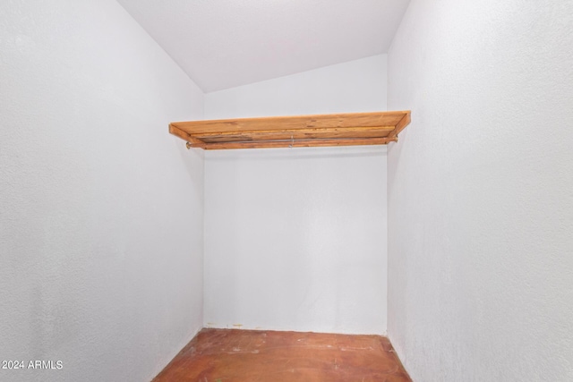 walk in closet with lofted ceiling