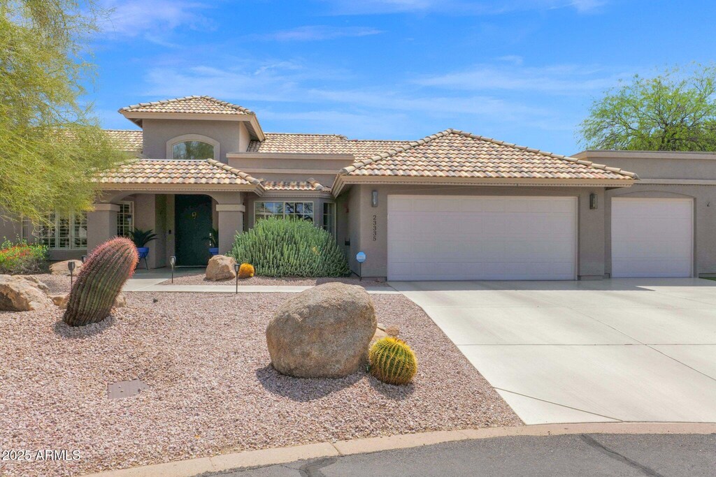 23335 N 91st St, Scottsdale, AZ 85255 - mediterranean / spanish-style house with a tiled roof, driveway, a garage, and stucco siding