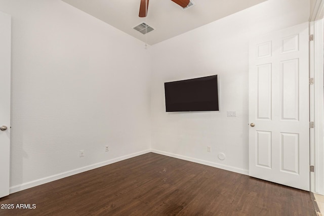 10502 W Bronco Trl, Peoria, AZ 85383 - unfurnished bedroom with dark wood-style floors, baseboards, and a ceiling fan