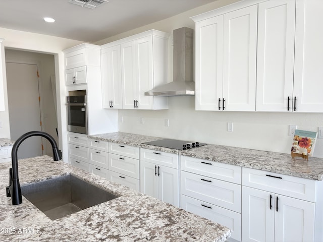 kitchen with white cabinetry, a sink, oven, wall chimney exhaust hood, and black electric cooktop