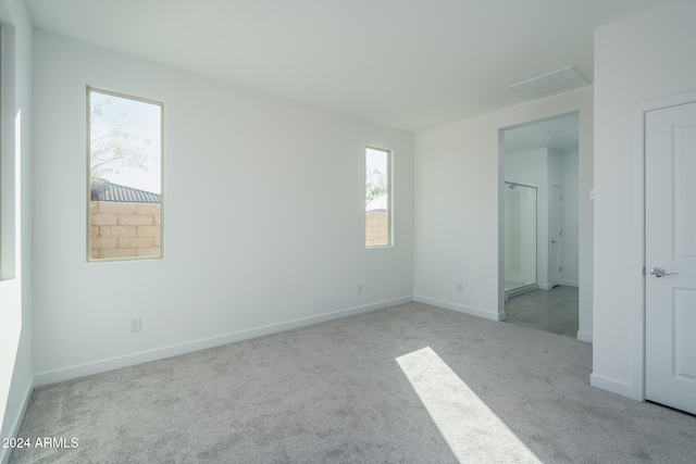 unfurnished room with light carpet