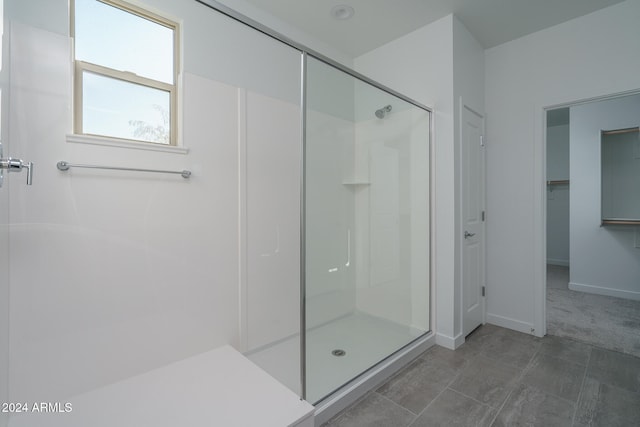 bathroom featuring a shower with shower door