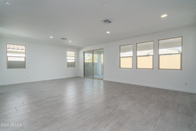 spare room featuring light wood-type flooring and a wealth of natural light