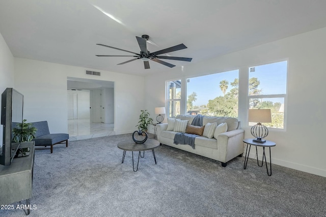 carpeted living room featuring ceiling fan