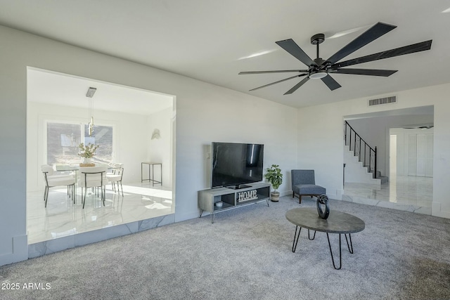 carpeted living room with ceiling fan