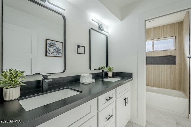 bathroom featuring vanity and tiled shower / bath combo