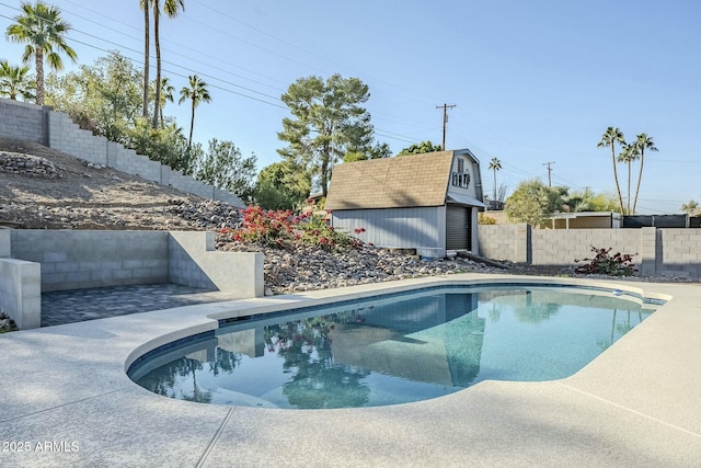 view of pool with an outbuilding