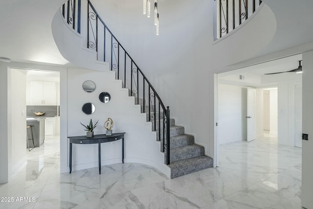 staircase featuring a towering ceiling