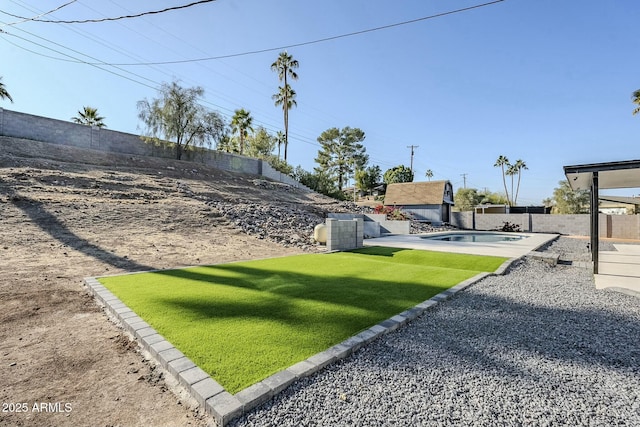 view of yard with a fenced in pool