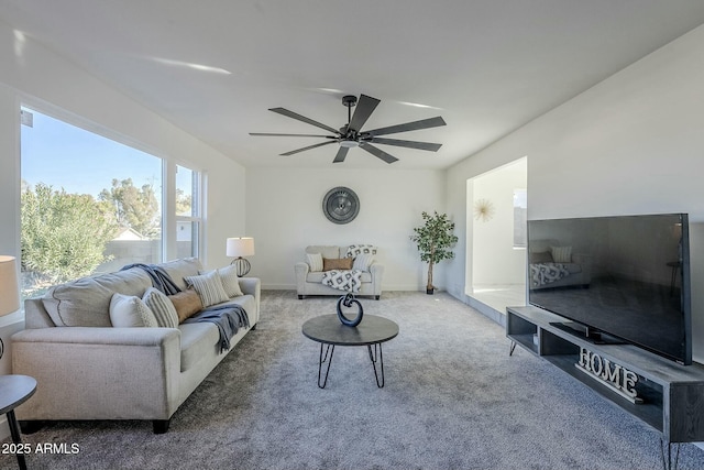 carpeted living room with ceiling fan