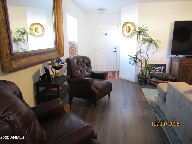 living area with wood finished floors and baseboards