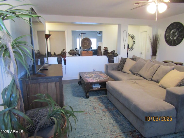 living area featuring a ceiling fan