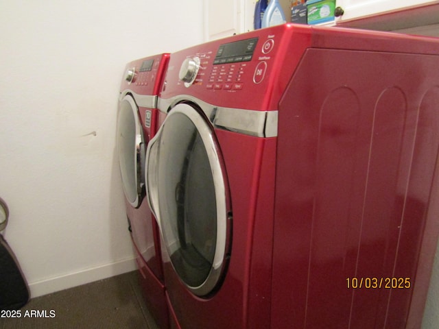 clothes washing area featuring baseboards and separate washer and dryer