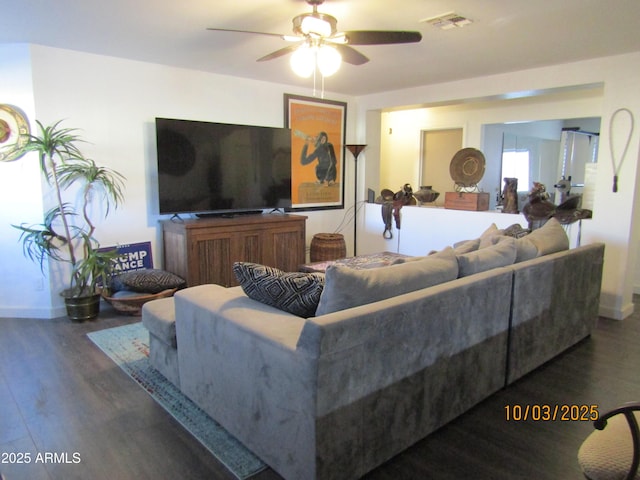 living area featuring a ceiling fan, wood finished floors, visible vents, and baseboards