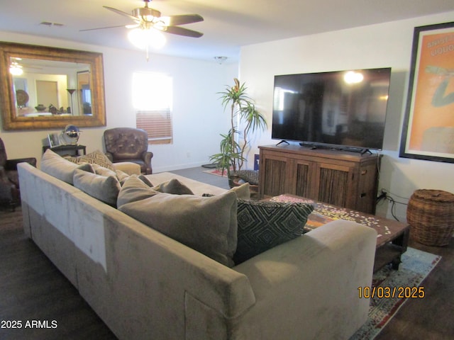 living area with a ceiling fan, wood finished floors, and visible vents