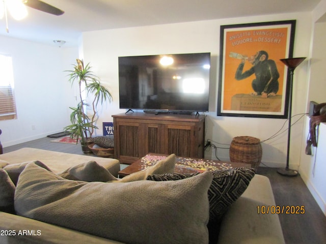 living room with wood finished floors, baseboards, and ceiling fan