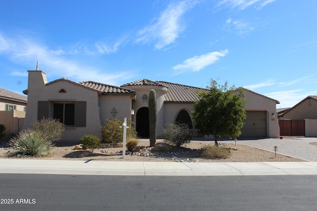 1319 N Chatsworth St, Mesa, AZ 85207 - mediterranean / spanish house with a garage, decorative driveway, a tiled roof, and stucco siding