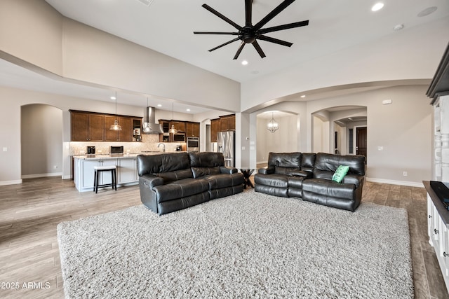 1319 N Chatsworth St, Mesa, AZ 85207 - living room with arched walkways, high vaulted ceiling, light wood-style flooring, and recessed lighting