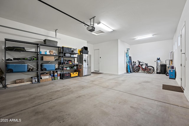 1319 N Chatsworth St, Mesa, AZ 85207 - garage with stainless steel refrigerator with ice dispenser and a garage door opener