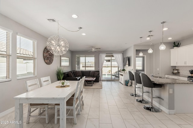 dining room featuring visible vents, recessed lighting, ceiling fan with notable chandelier, and baseboards