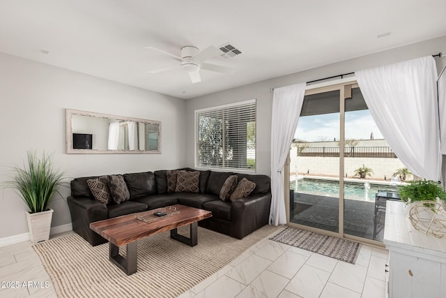 living room with visible vents, marble finish floor, a healthy amount of sunlight, and ceiling fan