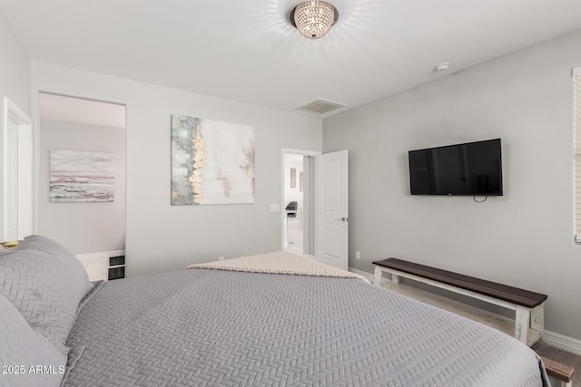 bedroom featuring baseboards and visible vents