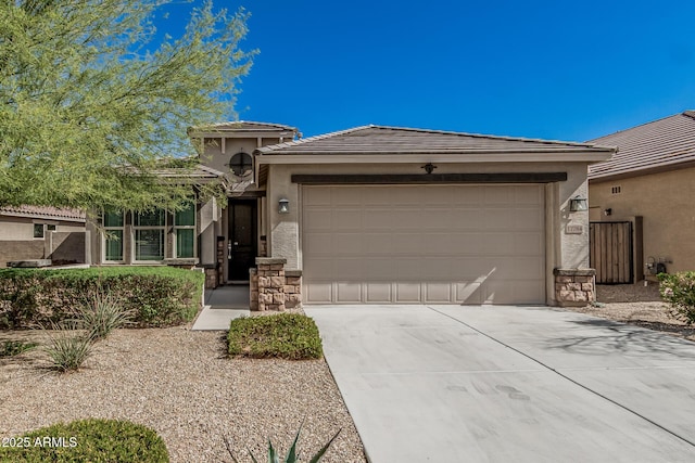 view of front of house featuring driveway, an attached garage, stucco siding, stone siding, and a tiled roof