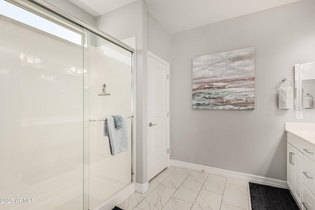 full bathroom featuring vanity, baseboards, marble finish floor, and a stall shower