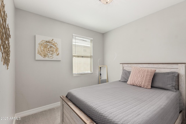 bedroom with carpet flooring and baseboards
