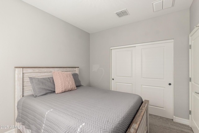 carpeted bedroom with a closet and visible vents