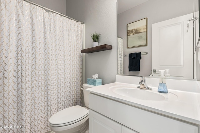 full bathroom featuring vanity and toilet