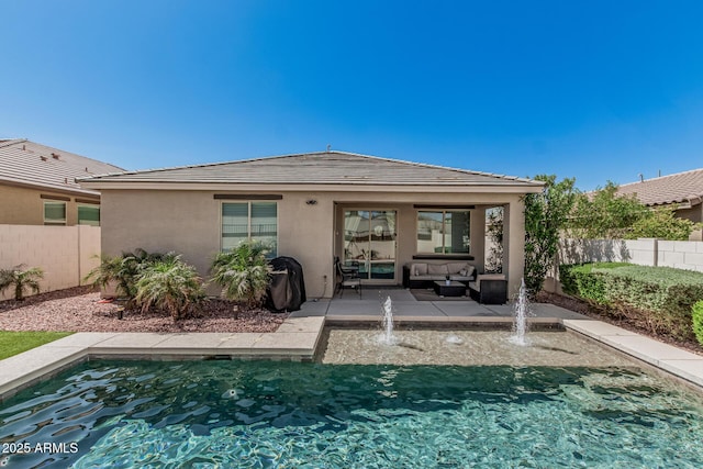 back of house with a patio area, stucco siding, and a fenced backyard