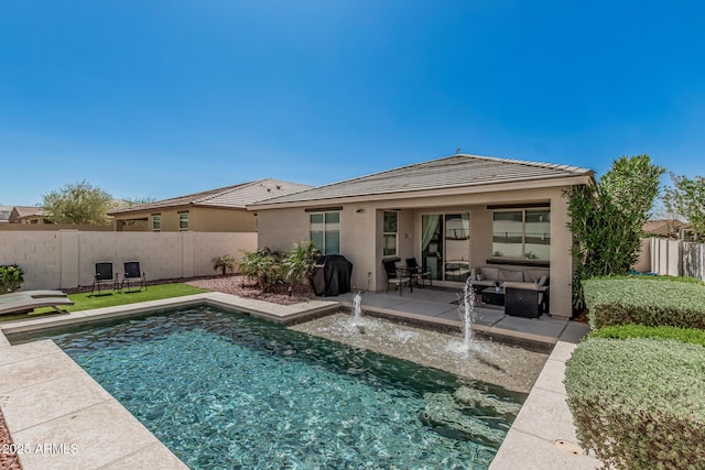 rear view of house with stucco siding, a patio, a fenced backyard, and a tiled roof