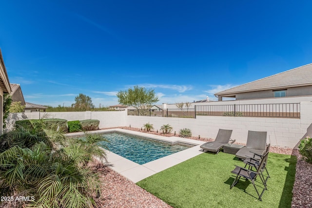 view of swimming pool featuring a fenced in pool, a lawn, and a fenced backyard