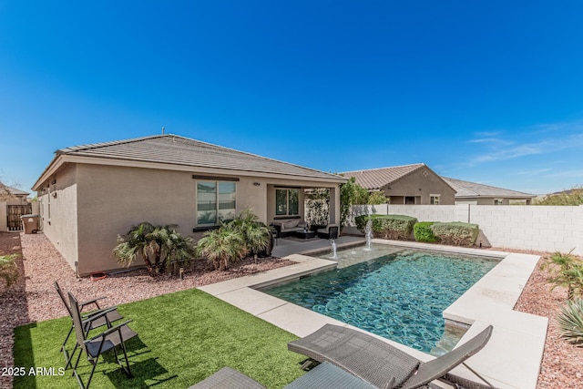 rear view of house featuring stucco siding, a fenced in pool, a fenced backyard, and a patio area