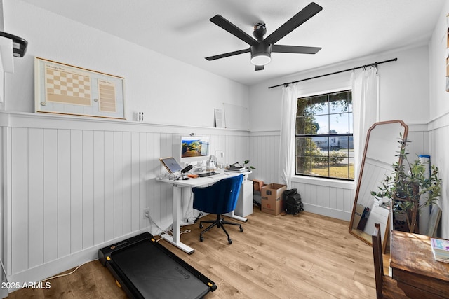 home office with ceiling fan and light hardwood / wood-style flooring