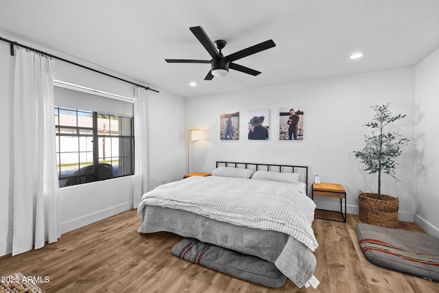 bedroom with ceiling fan and light hardwood / wood-style floors