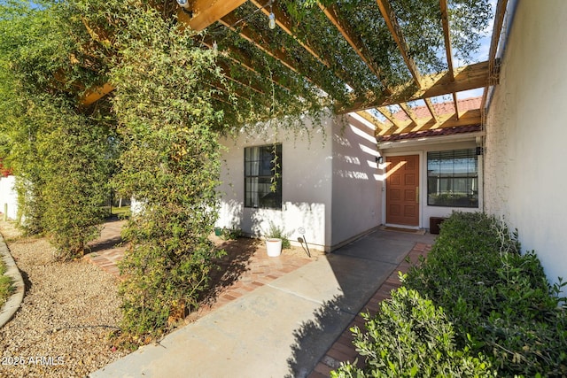 entrance to property with a pergola