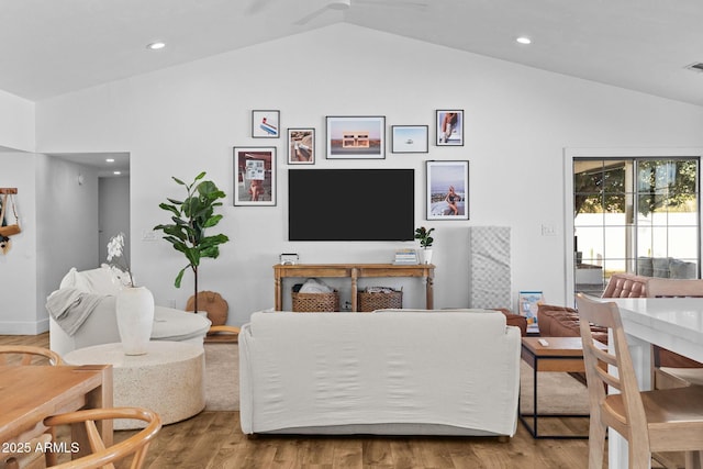 living room with hardwood / wood-style floors and lofted ceiling