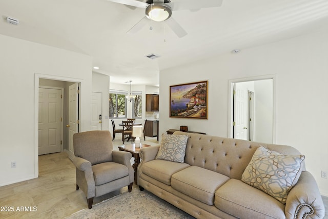 living room with baseboards, ceiling fan, and visible vents