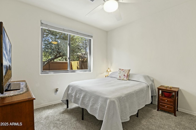 carpeted bedroom featuring baseboards and a ceiling fan