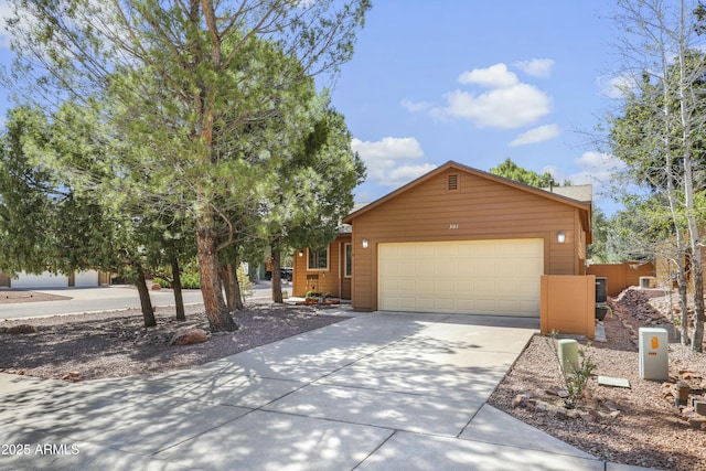 ranch-style house with an attached garage and concrete driveway