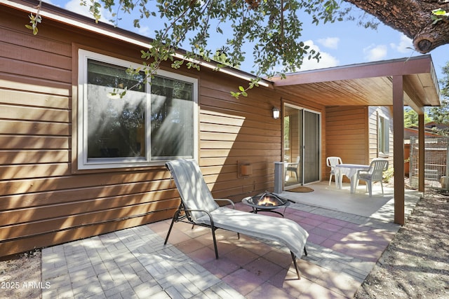 view of patio / terrace with an outdoor fire pit