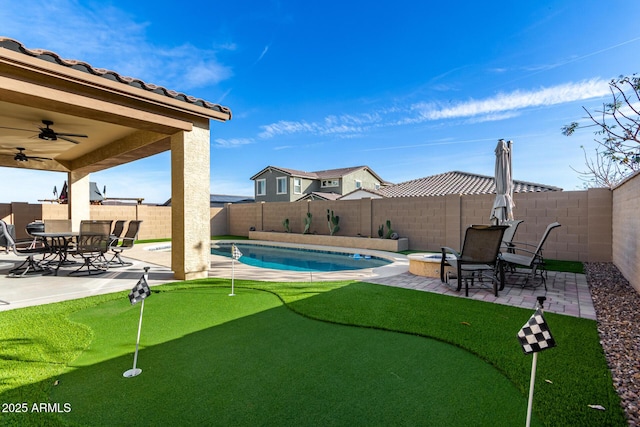 19889 W Montecito Ave, Litchfield Park, AZ 85340 - view of pool with a putting green, a patio, a ceiling fan, and a fenced backyard