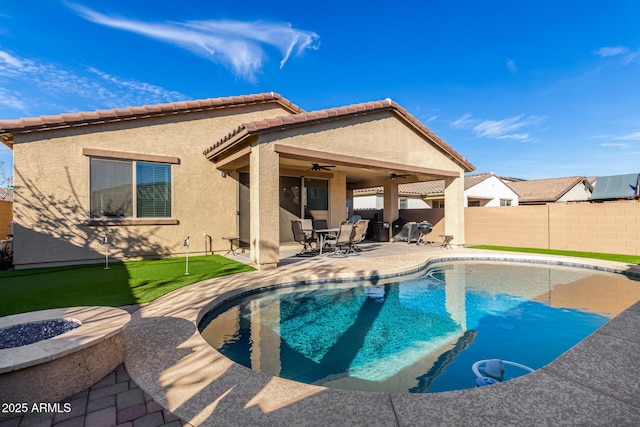19889 W Montecito Ave, Litchfield Park, AZ 85340 - view of pool with a ceiling fan, a patio, a fenced backyard, an outdoor fire pit, and an area to practice putting