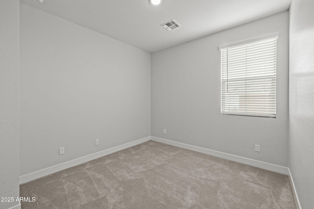 empty room featuring carpet floors and baseboards
