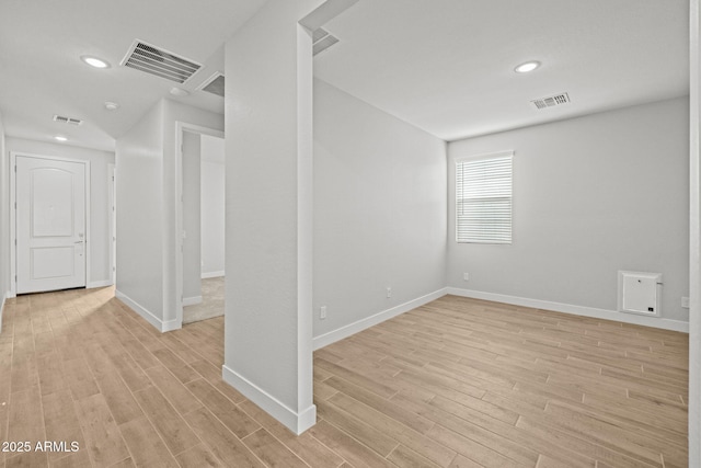 basement featuring light wood-style floors, baseboards, and recessed lighting