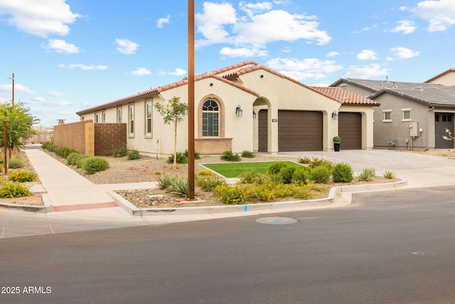 mediterranean / spanish-style house featuring an attached garage, fence, stucco siding, driveway, and a tile roof
