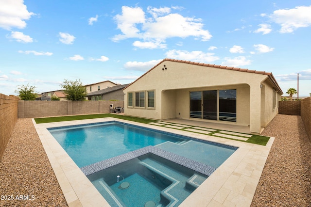 view of swimming pool featuring a fenced backyard, a patio, and a pool with connected hot tub